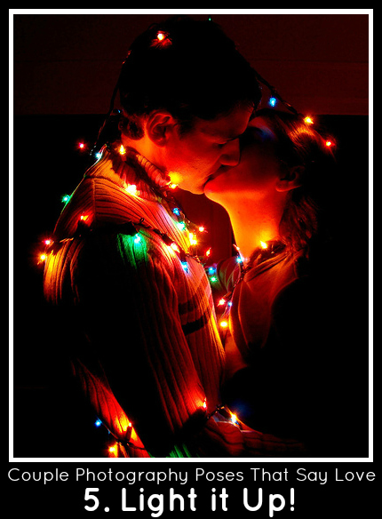 Couple Poses with Christmas Lights