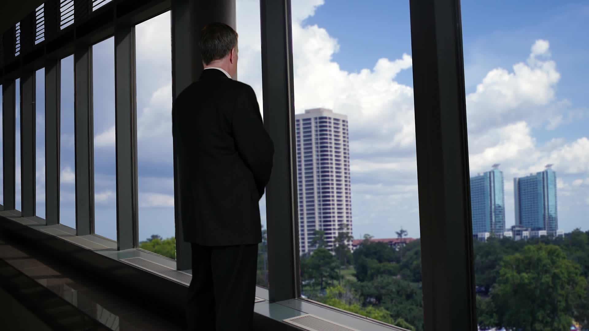 Businessman Looking Out Office Window